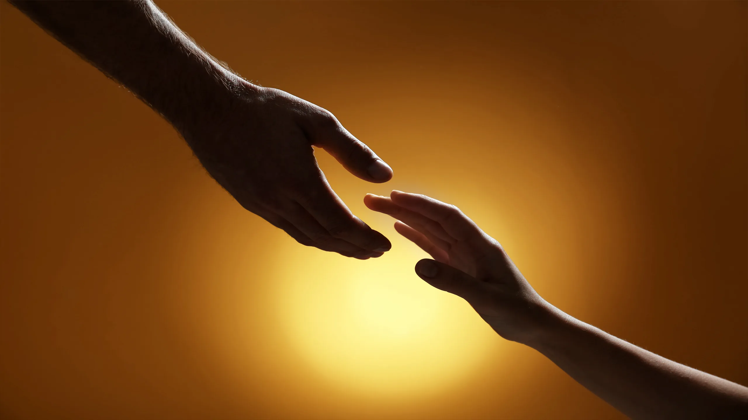 Two hands reaching toward each other